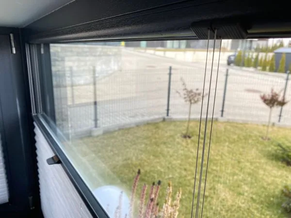 Plisy w czarnej kuchni w realizacji na Śląsku - detal prowadzenia plis przy czarnej stolarki